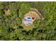 An aerial view displays the home nestled in lush greenery, featuring a private pool and expansive yard at 7720 Milam Rd, Winston, GA 30187