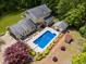 Aerial view of home featuring a large in-ground swimming pool and surrounding patio at 7720 Milam Rd, Winston, GA 30187