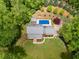 Aerial view of a private home with a swimming pool surrounded by lush greenery at 7720 Milam Rd, Winston, GA 30187