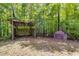 Backyard with a covered shelter and an old stove, nestled among trees and greenery at 7720 Milam Rd, Winston, GA 30187
