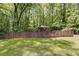 Large backyard with tall trees and a play area at 7720 Milam Rd, Winston, GA 30187