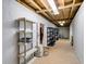 Spacious unfinished basement with shelving and exposed beams, ideal for storage or customization at 7720 Milam Rd, Winston, GA 30187