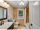 Elegant bathroom features a marble sink, mirror, shower with curtain, and window at 7720 Milam Rd, Winston, GA 30187
