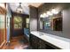 Well-lit bathroom featuring a bathtub, stylish vanity, and wood flooring at 7720 Milam Rd, Winston, GA 30187