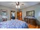 Bedroom featuring hardwood floors, ceiling fan, dresser and doorway to a bathroom at 7720 Milam Rd, Winston, GA 30187