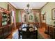 Formal dining room featuring a chandelier, hardwood floors, and traditional décor for elegant gatherings at 7720 Milam Rd, Winston, GA 30187