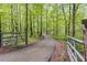 Private driveway winding through a lush, green forest, gated for added security and seclusion at 7720 Milam Rd, Winston, GA 30187