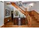 Inviting foyer with hardwood floors, stairs, a chandelier, and decorative woodwork adding classic charm at 7720 Milam Rd, Winston, GA 30187