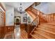Elegant foyer with hardwood floors, a staircase, a chandelier, and decorative woodwork, showcasing classic elegance at 7720 Milam Rd, Winston, GA 30187