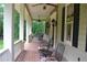 Inviting front porch with mosaic-tiled floor and wrought-iron seating perfect for enjoying the outdoors at 7720 Milam Rd, Winston, GA 30187