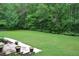 Well-manicured green front yard surrounded by trees at 7720 Milam Rd, Winston, GA 30187