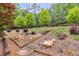 Landscaped yard with small water feature, walking stones, and various bushes and trees at 7720 Milam Rd, Winston, GA 30187