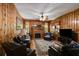 Cozy living room with wood-paneled walls, a fireplace, and comfortable seating for relaxing evenings at 7720 Milam Rd, Winston, GA 30187