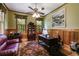 Cozy home office with wood-paneled walls, a ceiling fan, and a comfortable sitting area for work or relaxation at 7720 Milam Rd, Winston, GA 30187