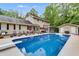 Inviting backyard oasis with sparkling pool, diving board, and patio seating area at 7720 Milam Rd, Winston, GA 30187