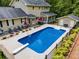 A backyard showcasing a private in-ground pool, lounge seating, and patio area perfect for outdoor entertaining at 7720 Milam Rd, Winston, GA 30187
