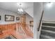 Well-lit stairway featuring wood railings, carpeted steps, and decorative wall panels at 7720 Milam Rd, Winston, GA 30187