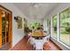 Charming sunroom with brick floors, multiple windows, and a cozy dining area at 7720 Milam Rd, Winston, GA 30187