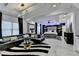 Large bedroom featuring a seating area, fireplace, bar, and spacious sleeping area at 8525 Saint Marlo Fairway Drive, Duluth, GA 30097
