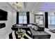 Spacious bedroom with a fireplace and sleek black sectional at 8525 Saint Marlo Fairway Drive, Duluth, GA 30097