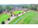 Aerial view of a beautiful home overlooking a lush green golf course with manicured lawns and mature trees at 8525 Saint Marlo Fairway Drive, Duluth, GA 30097