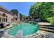 Tranquil backyard view featuring a sparkling pool, diving board, and surrounding lush greenery for ultimate privacy at 8525 Saint Marlo Fairway Drive, Duluth, GA 30097