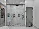 Luxurious walk-in shower with marble tile, modern fixtures, and a glass enclosure at 8525 Saint Marlo Fairway Drive, Duluth, GA 30097