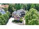 Beautiful brick home with lush landscaping, circular driveway, and grand facade at 8525 Saint Marlo Fairway Way, Duluth, GA 30097