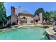 Beautiful backyard with a swimming pool, hot tub, and outdoor dining area, ideal for entertaining and relaxing at 8525 Saint Marlo Fairway Way, Duluth, GA 30097
