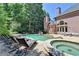 Lovely backyard featuring a pool, hot tub, patio, and a well-maintained lawn for outdoor enjoyment at 8525 Saint Marlo Fairway Way, Duluth, GA 30097