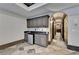 Bar area with custom cabinetry, under-counter refrigerator, and marble flooring, perfect for entertaining guests in style at 8525 Saint Marlo Fairway Way, Duluth, GA 30097