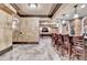 Finished basement bar with custom cabinetry, stone accents, and a full bar setup at 8525 Saint Marlo Fairway Way, Duluth, GA 30097