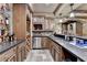 Basement bar showcasing dark countertops, stainless steel appliances, wooden cabinets, and wine storage at 8525 Saint Marlo Fairway Way, Duluth, GA 30097