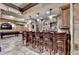 Basement bar with wooden barstools, a pool table, and custom lighting at 8525 Saint Marlo Fairway Way, Duluth, GA 30097