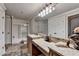 Bathroom featuring granite counters, dual sinks and a shower at 8525 Saint Marlo Fairway Way, Duluth, GA 30097