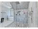 A luxurious bathroom featuring a frameless glass shower, soaking tub, modern vanity and fixtures, plus designer tile throughout at 8525 Saint Marlo Fairway Way, Duluth, GA 30097