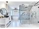 A luxurious bathroom featuring a frameless glass shower, soaking tub, modern vanity and fixtures, plus designer tile throughout at 8525 Saint Marlo Fairway Way, Duluth, GA 30097