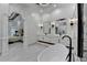 This modern bathroom has dual sinks, a soaking tub, and large mirrors at 8525 Saint Marlo Fairway Way, Duluth, GA 30097