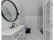 Elegant bathroom featuring a modern vanity, round mirror, sleek fixtures, and a glass-enclosed shower at 8525 Saint Marlo Fairway Way, Duluth, GA 30097