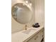 Modern bathroom with gold fixtures, bright vanity lighting, and a sleek countertop at 8525 Saint Marlo Fairway Way, Duluth, GA 30097