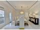 Luxurious dining room with modern chandelier, sleek black console, and seating for ten guests at 8525 Saint Marlo Fairway Way, Duluth, GA 30097