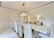 Chic dining room with chandelier lighting, white table, and comfortable seating for a luxurious experience at 8525 Saint Marlo Fairway Way, Duluth, GA 30097