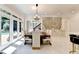 The dining room provides ample space with a wooden table, white chairs, and outdoor views from multiple windows at 8525 Saint Marlo Fairway Way, Duluth, GA 30097