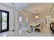 Elegant dining room with luxurious chandelier, marble accent wall, and seating for ten at 8525 Saint Marlo Fairway Way, Duluth, GA 30097