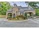 Stone community entrance with manicured landscaping and gatehouse at 8525 Saint Marlo Fairway Way, Duluth, GA 30097