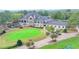 Impressive home exterior with stone accents, covered patio, and putting green offering an outdoor retreat at 8525 Saint Marlo Fairway Way, Duluth, GA 30097