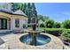 Beautiful outdoor fountain with tile and stone accents surrounded by lush landscaping at 8525 Saint Marlo Fairway Way, Duluth, GA 30097