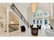 Grand foyer with staircase, stylish chandelier, and ample seating area at 8525 Saint Marlo Fairway Way, Duluth, GA 30097
