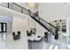 Spacious foyer with staircase and bright lighting at 8525 Saint Marlo Fairway Way, Duluth, GA 30097