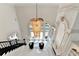 Bright foyer featuring a sparkling chandelier, staircase, and grand entrance, offering a luxurious welcome at 8525 Saint Marlo Fairway Way, Duluth, GA 30097